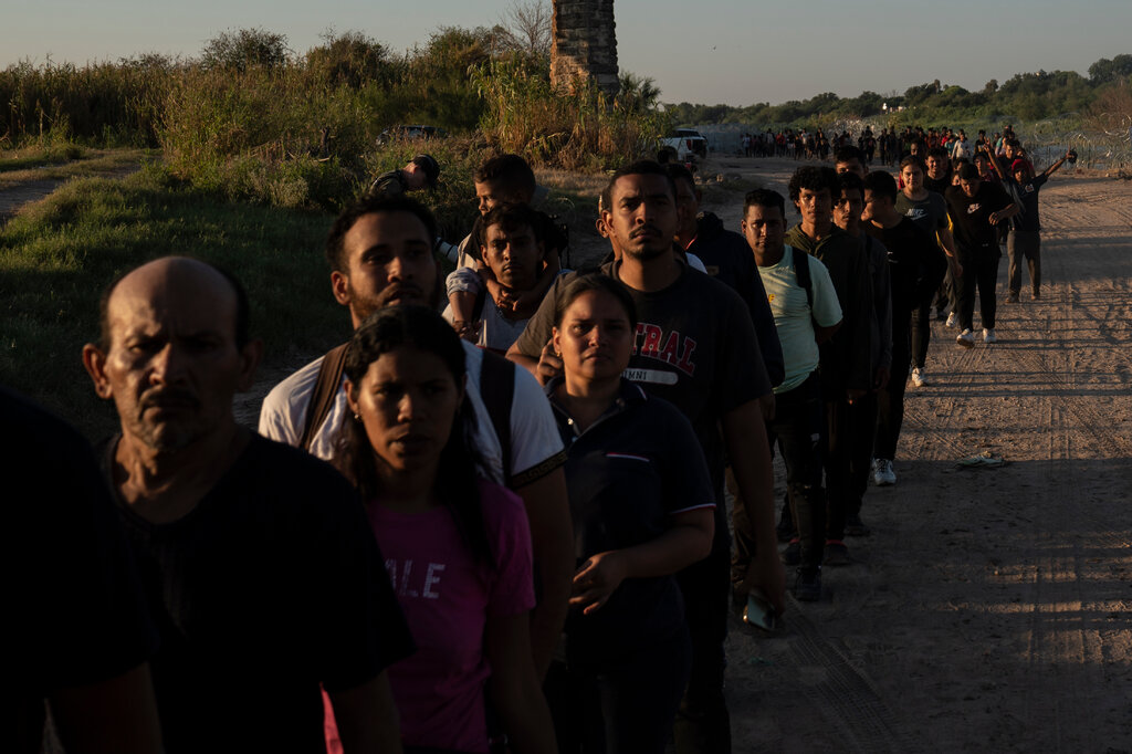 immigrants in a line waiting