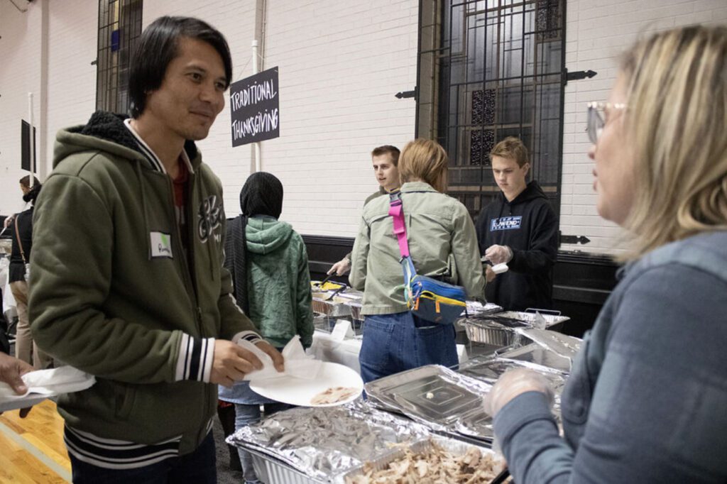 refugees eating Thanksgiving dinner