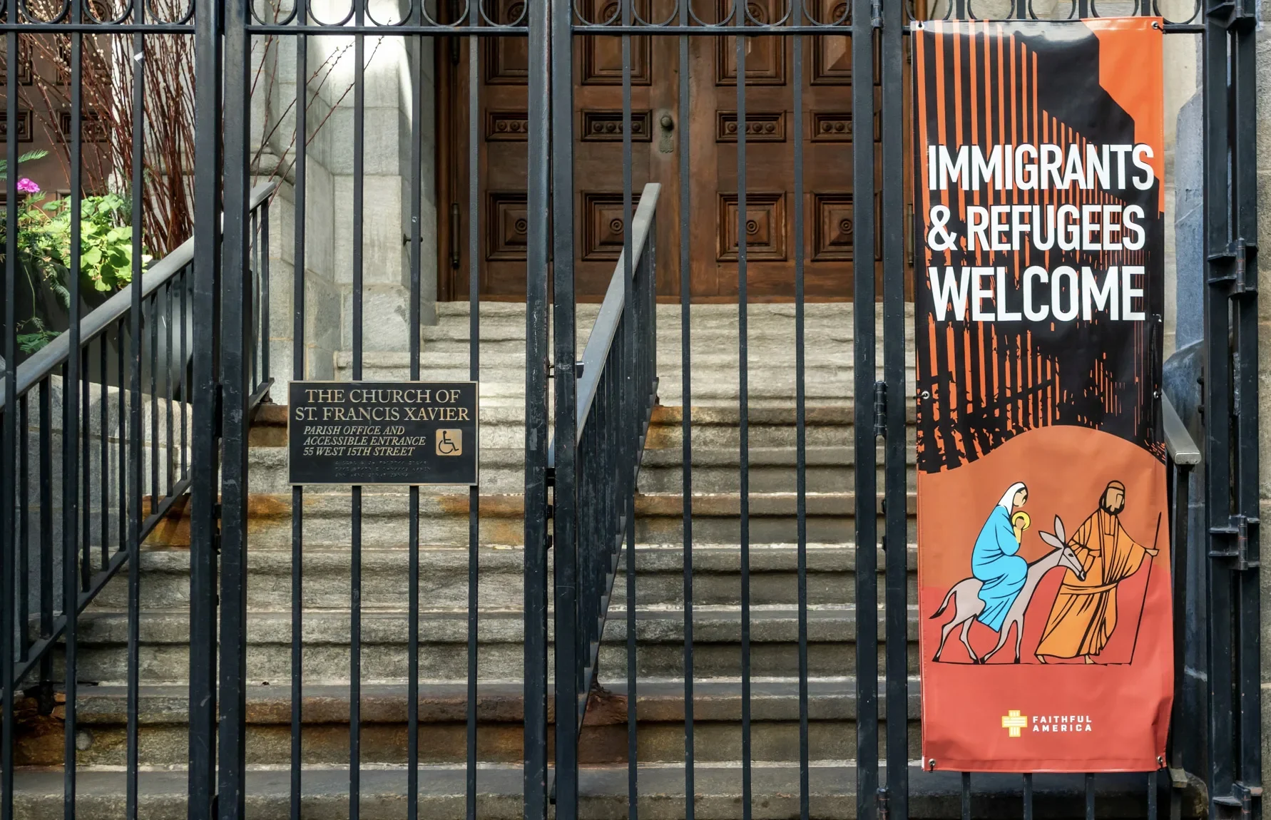 immigrants welcome sign at church gate