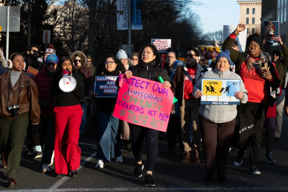 People march to the state Capitol during a rally in support of the TRUST Act on March 3, 2025